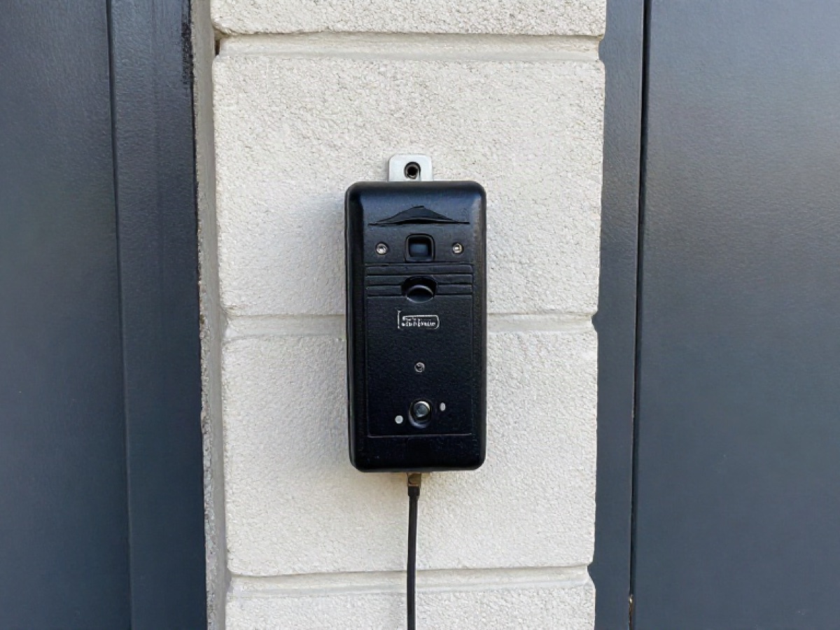 Proximity card reader mounted on a block wall beside a steel door